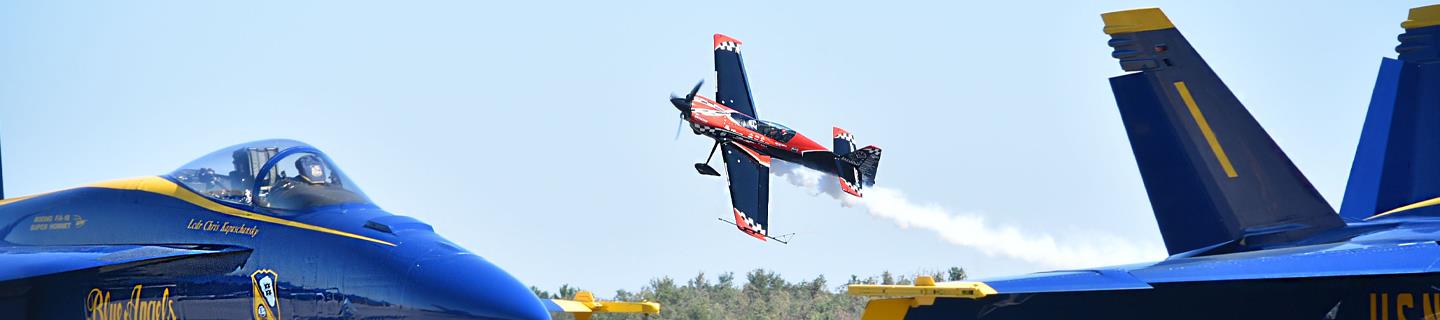 Rob Holland flying low over parked Blue Angel jets